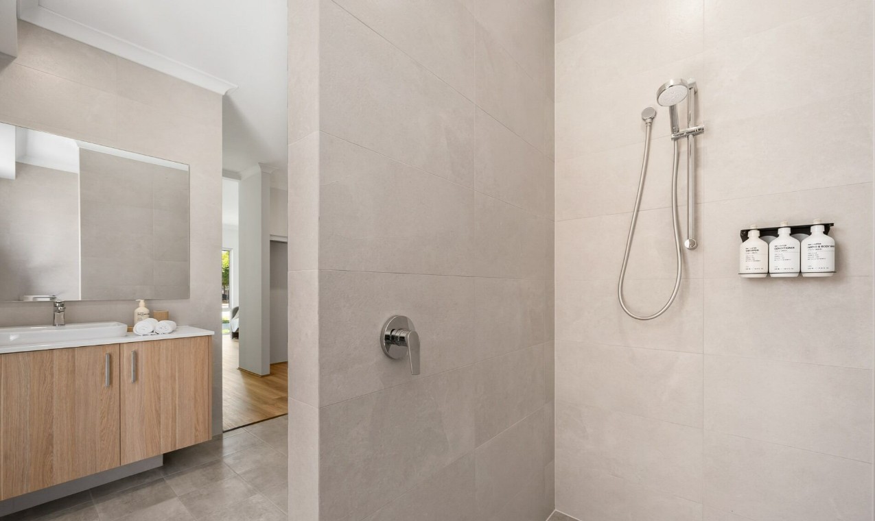Spotless modern bathroom with white towels and clean vanity in a rental apartment
