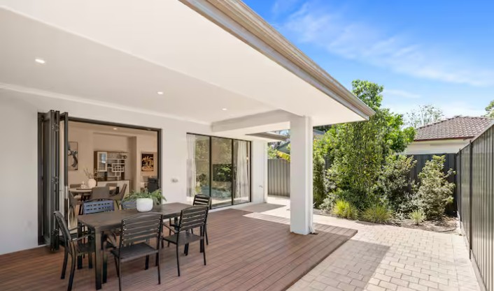 Clean rental balcony with outdoor chairs and potted plants