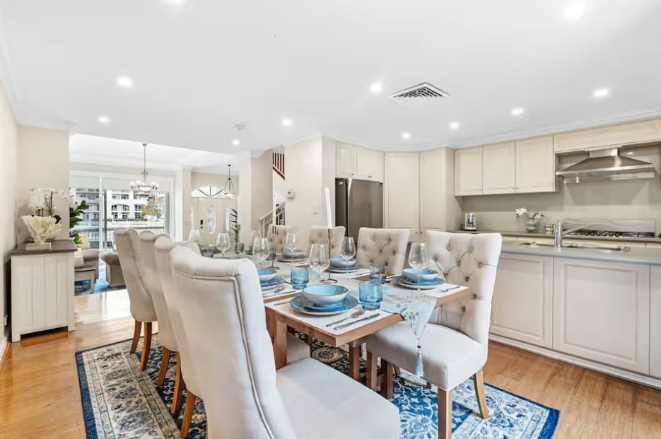 Modern dining area with clean table setting in a short-stay rental